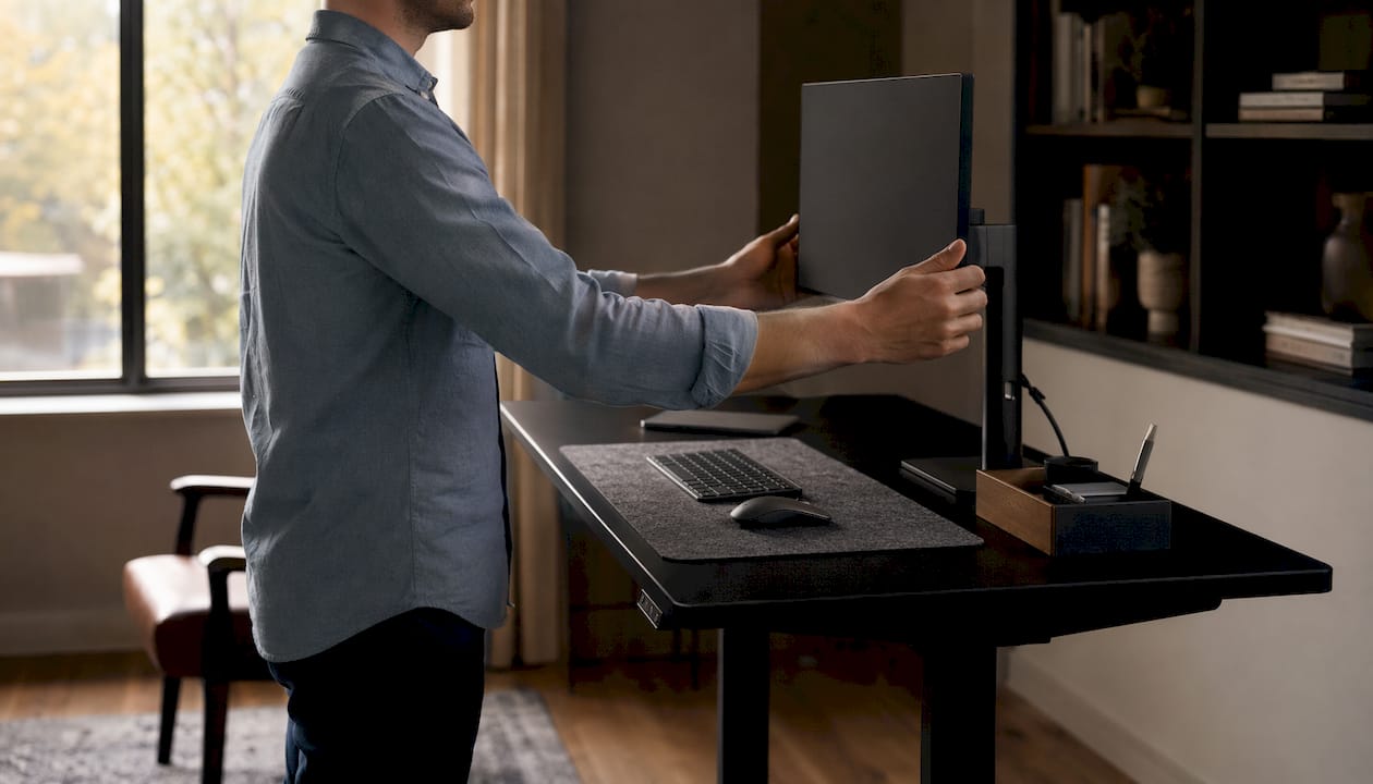 Close-up of arms demonstrating 90-degree elbow angle on standing desk