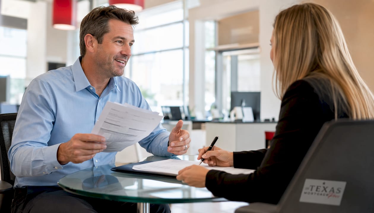 Man submitting mortgage documents at bank counter