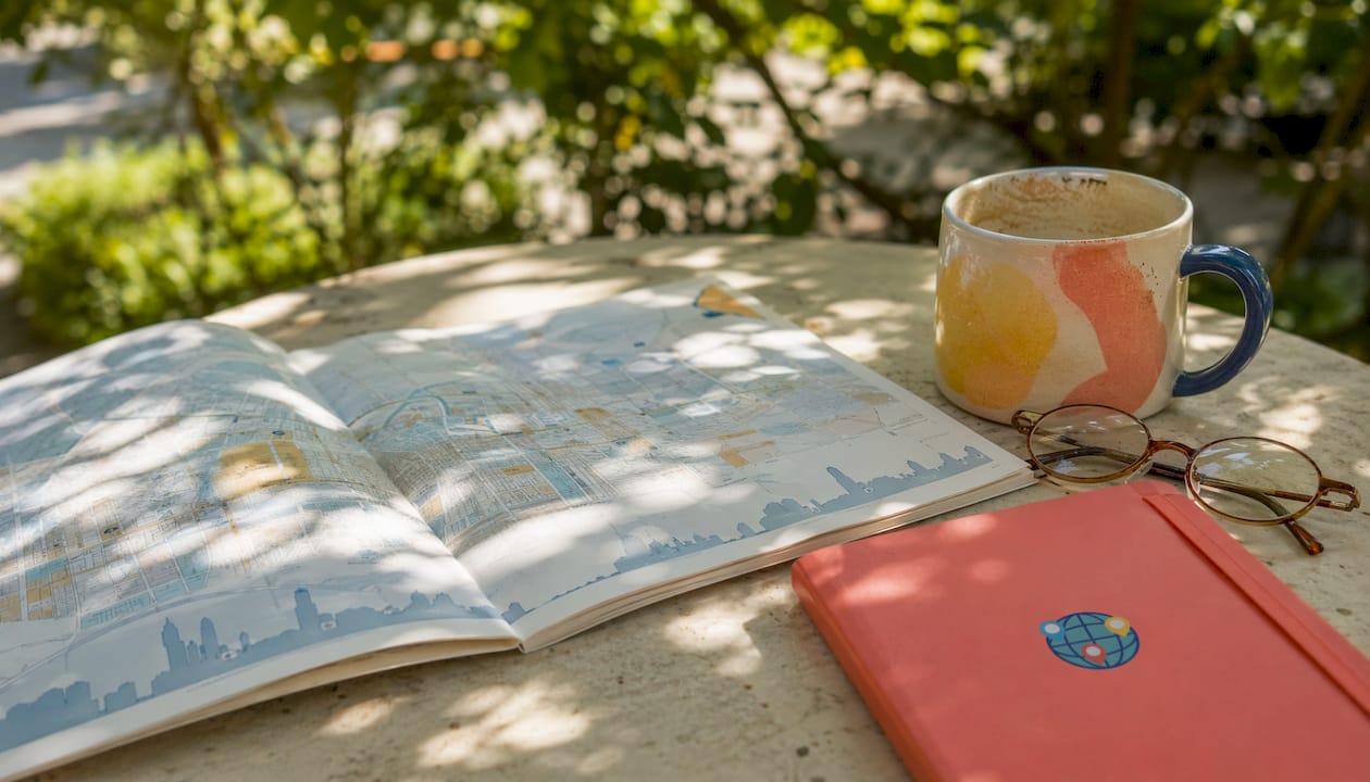 Open city map with glasses and coffee cup
