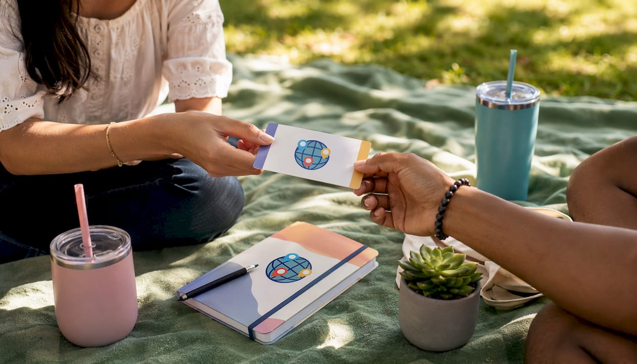 Two hands exchanging quiz result card at café table