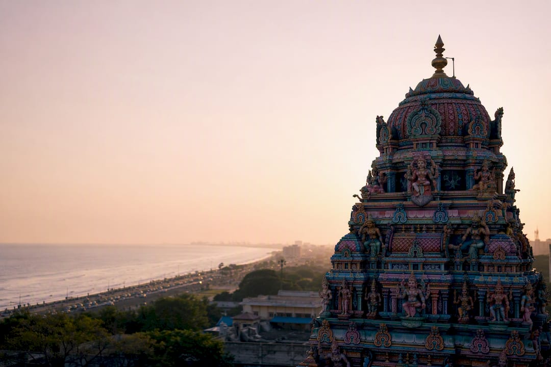 Colorful Tamil temple gopuram with coastal backdrop