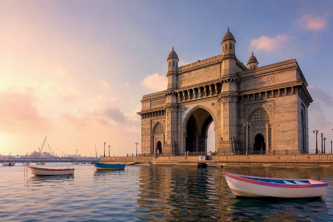 Stylized Gateway of India arch with water and boats
