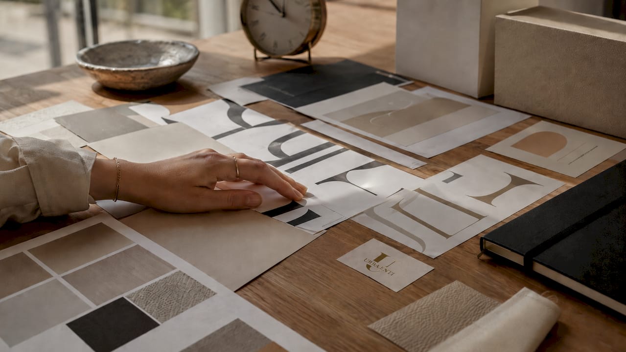 Hands examining branding identity materials