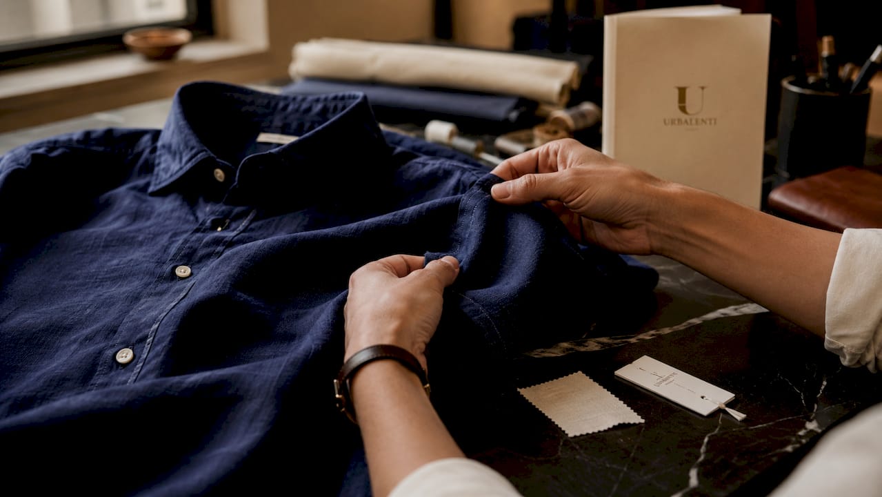 Close-up of hands inspecting luxury shirt quality