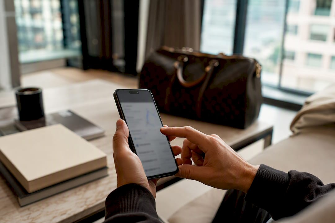 Hands holding phone with package tracking