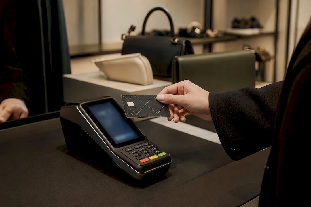 Hand using credit card at payment terminal