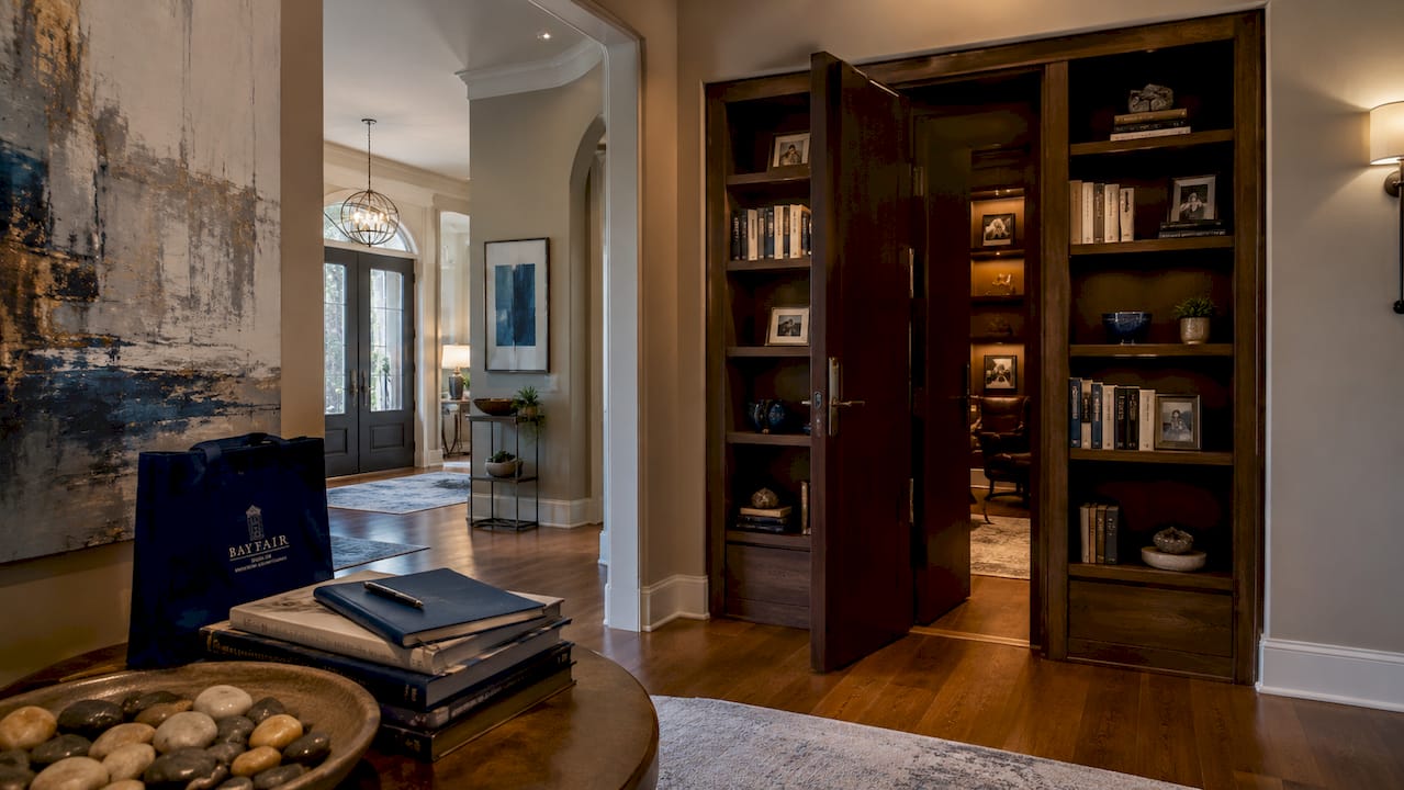 Overhead view of luxury home hallway with hidden room entrance