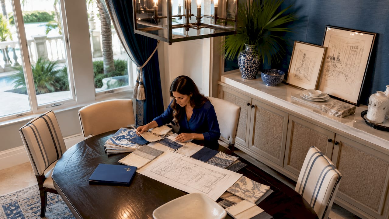 Interior designer reviewing fabric swatches in estate living room