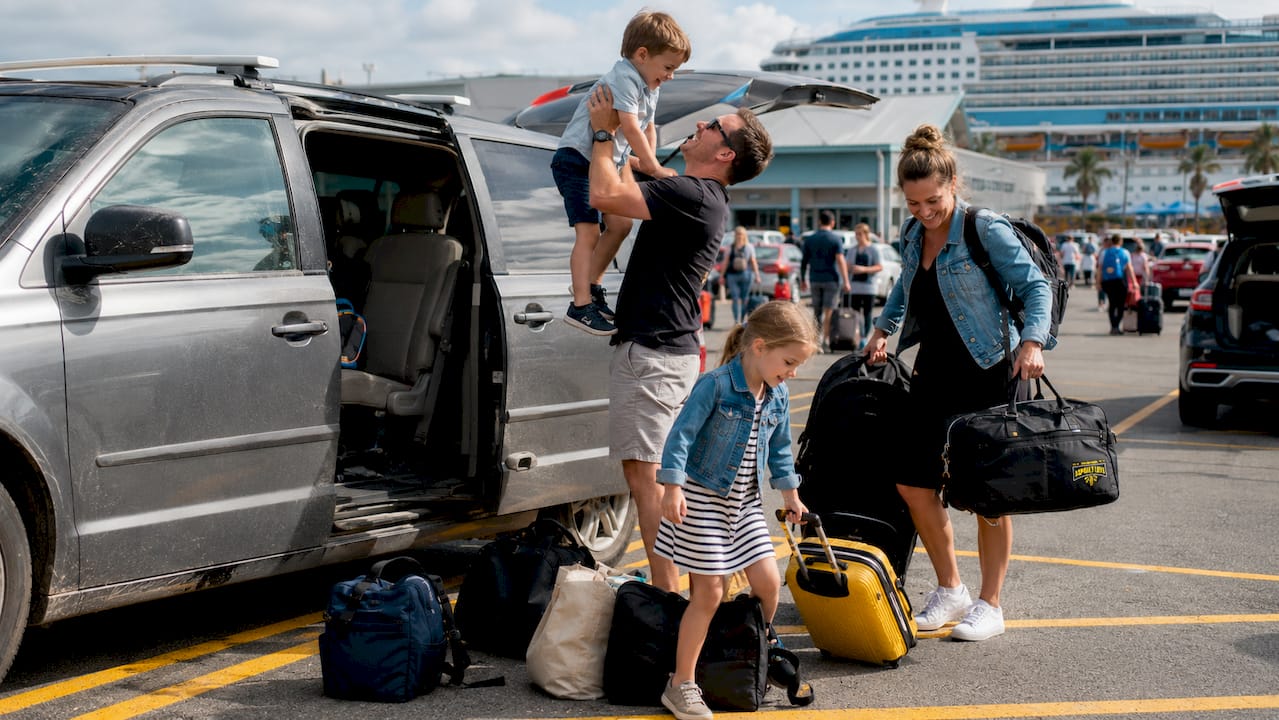 Family unloading car at cruise terminal parking