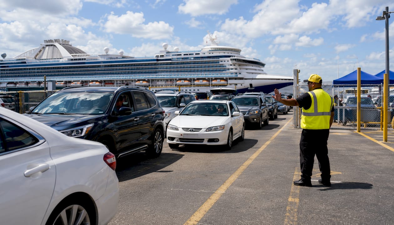 Busy cruise parking lot with vehicle queues and attendants