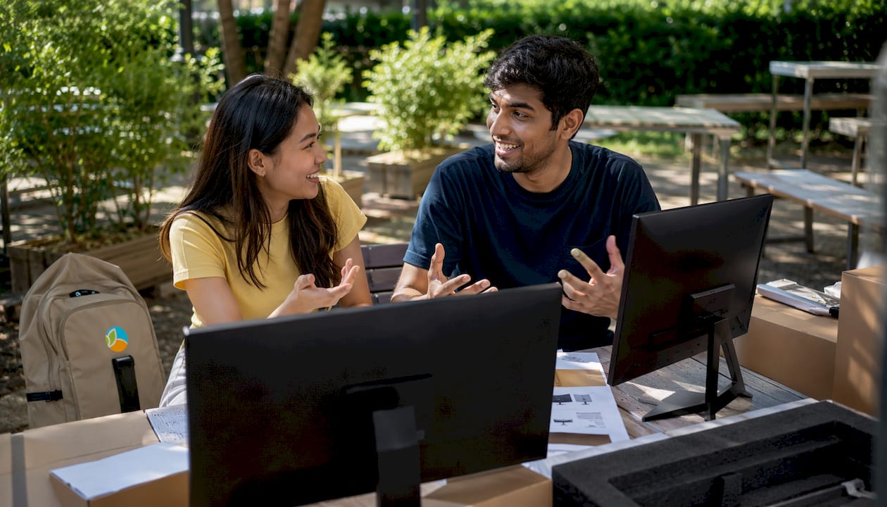 Two people discussing gaming monitors and specs