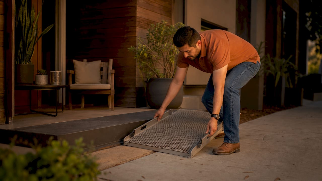Hands installing access ramp at rental entrance
