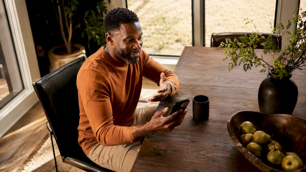 Man communicating with Houston rental host via phone