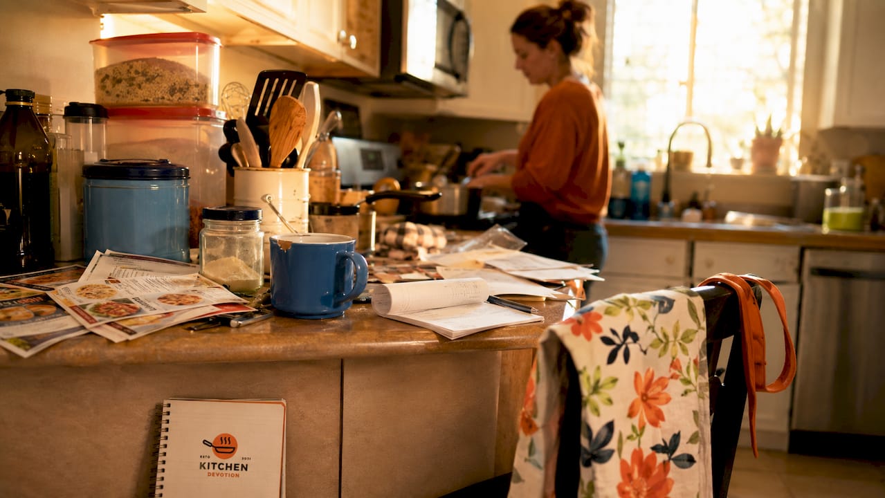 Cluttered kitchen countertop with appliances and mail