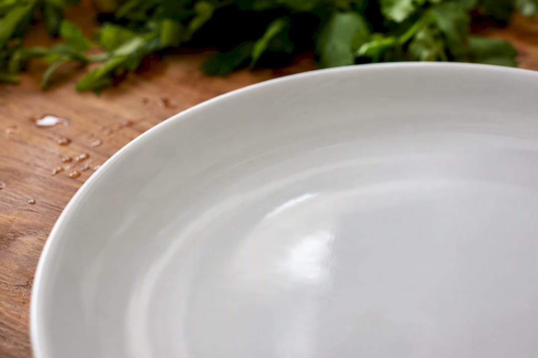 Close-up of smooth glazed porcelain dinner plate