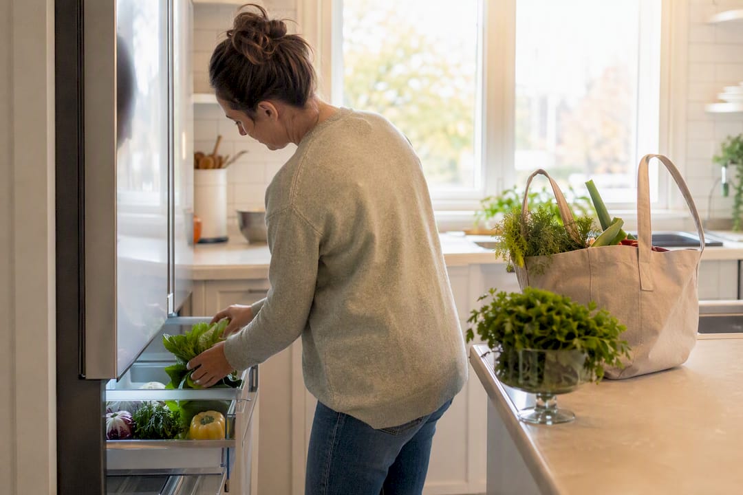 Person placing produce in fridge drawer quietly