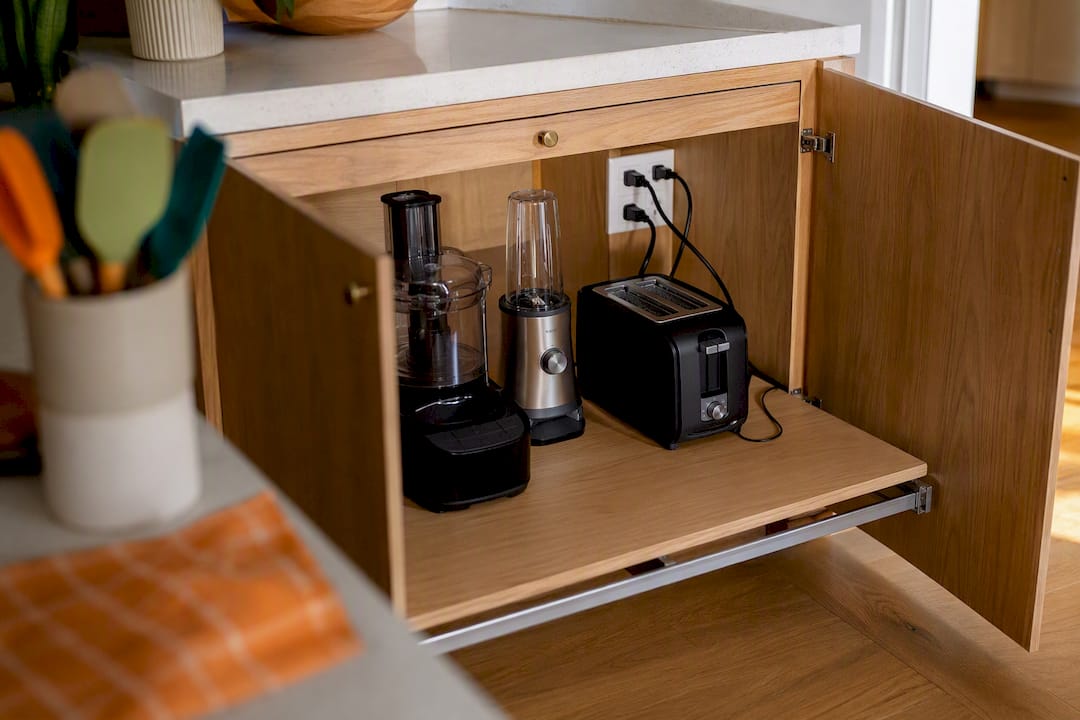 Appliance garage interior with side outlet