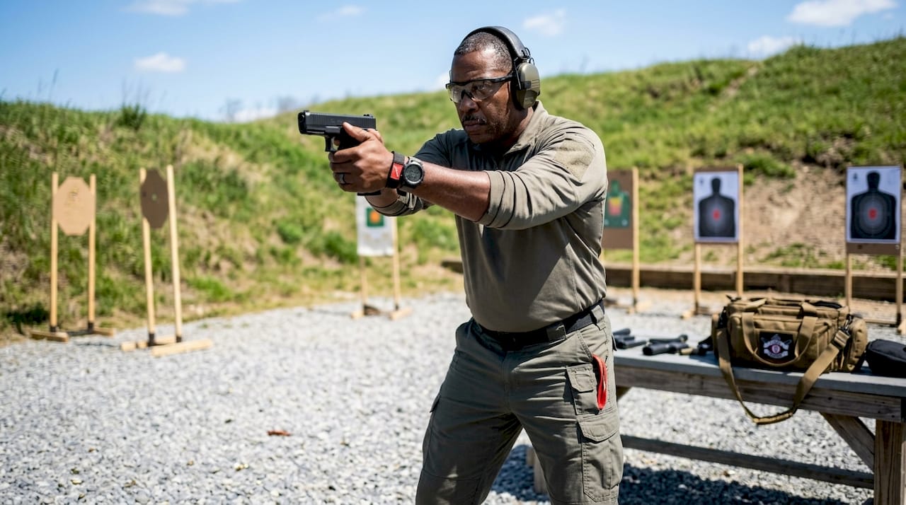 Male shooter demonstrating safe stance at indoor range