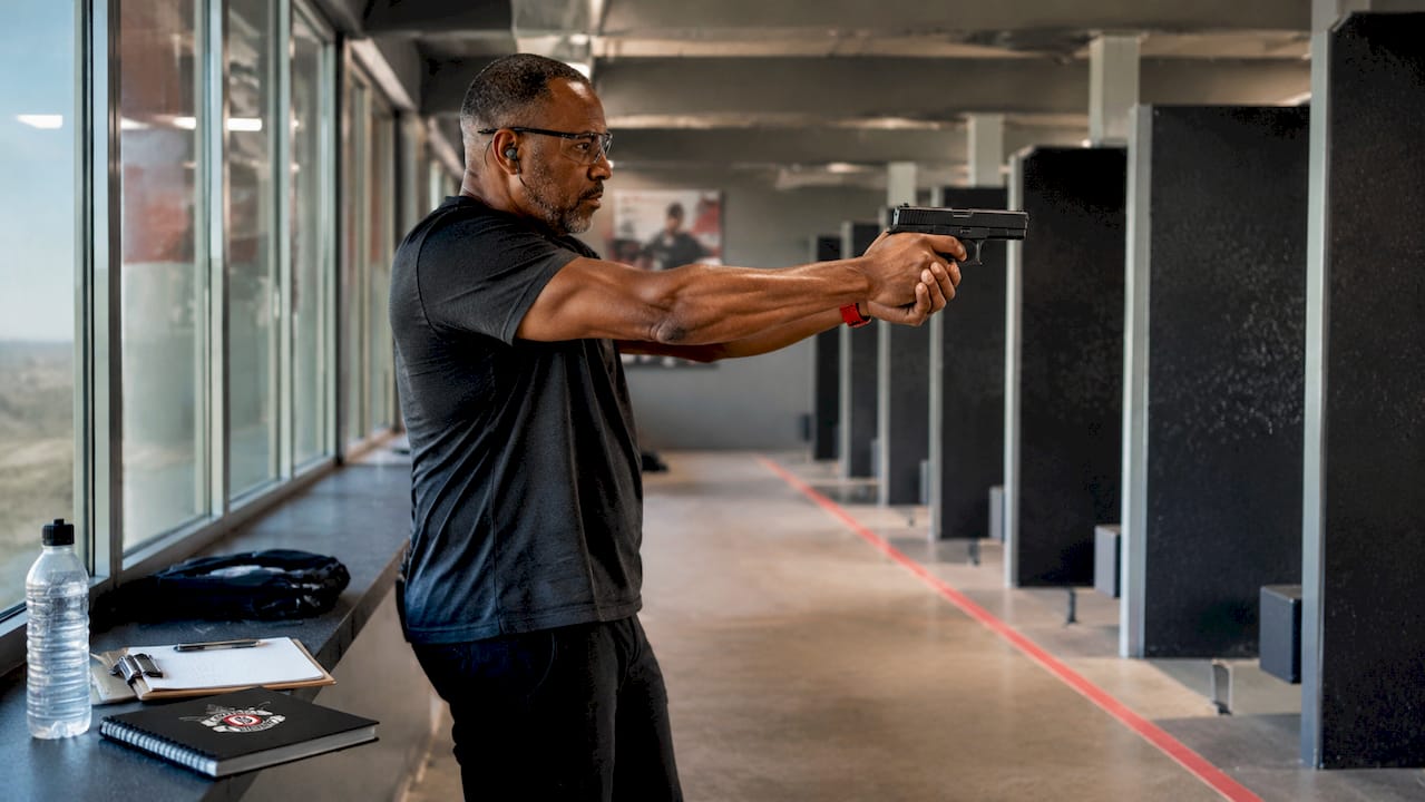 Man practicing dry-fire at shooting range