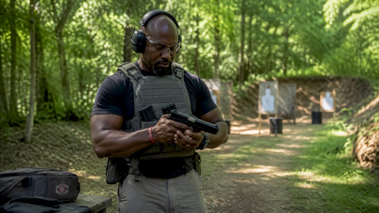 Man safely handling firearm indoors