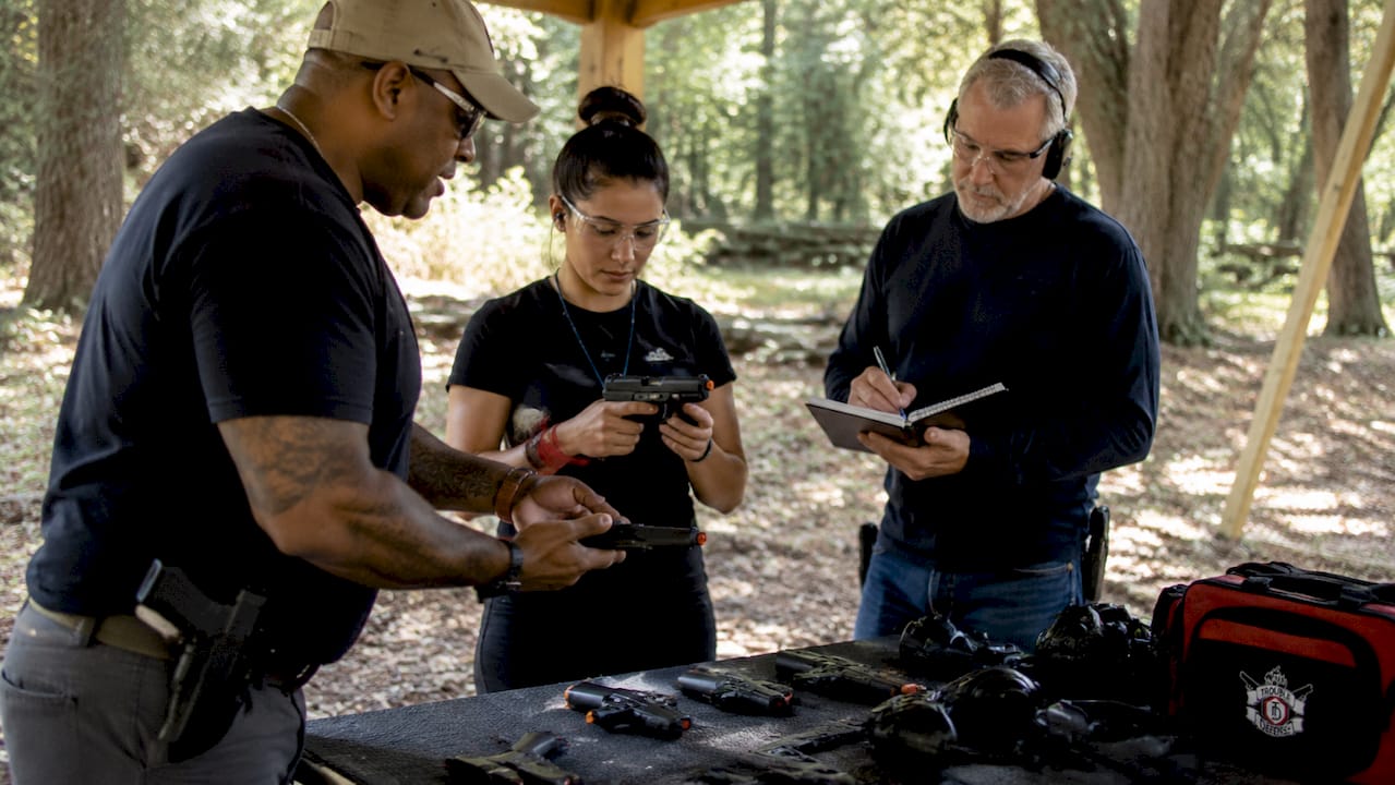 Instructor demonstrating safe handgun handling in class