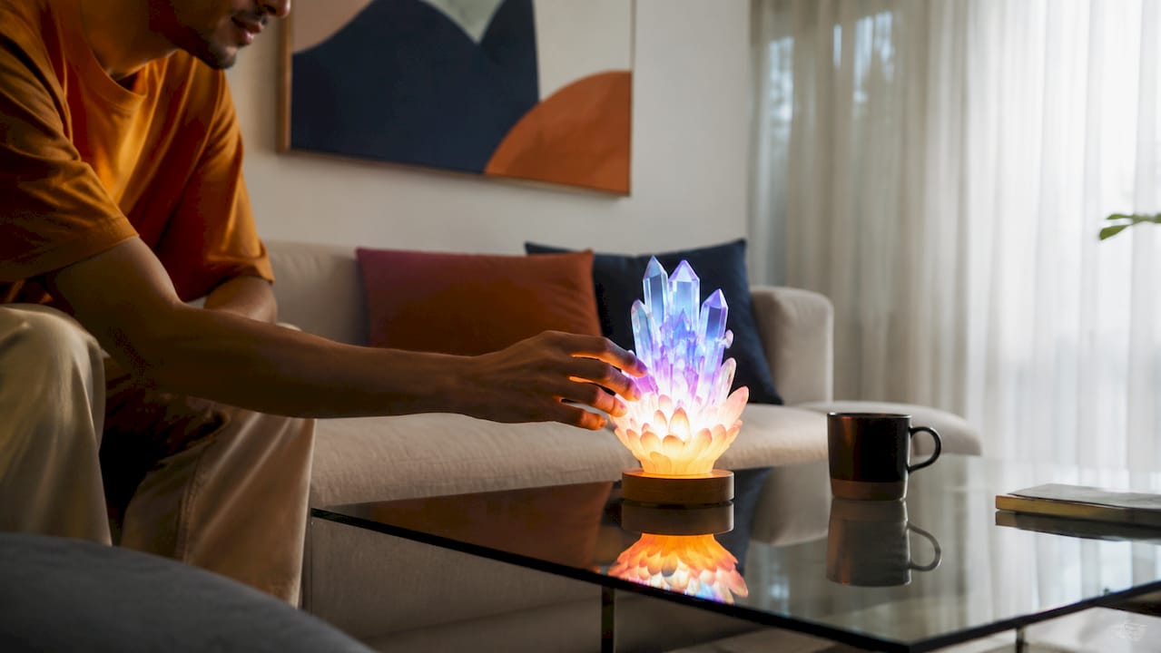 Hand adjusting LED mood lamp on side table