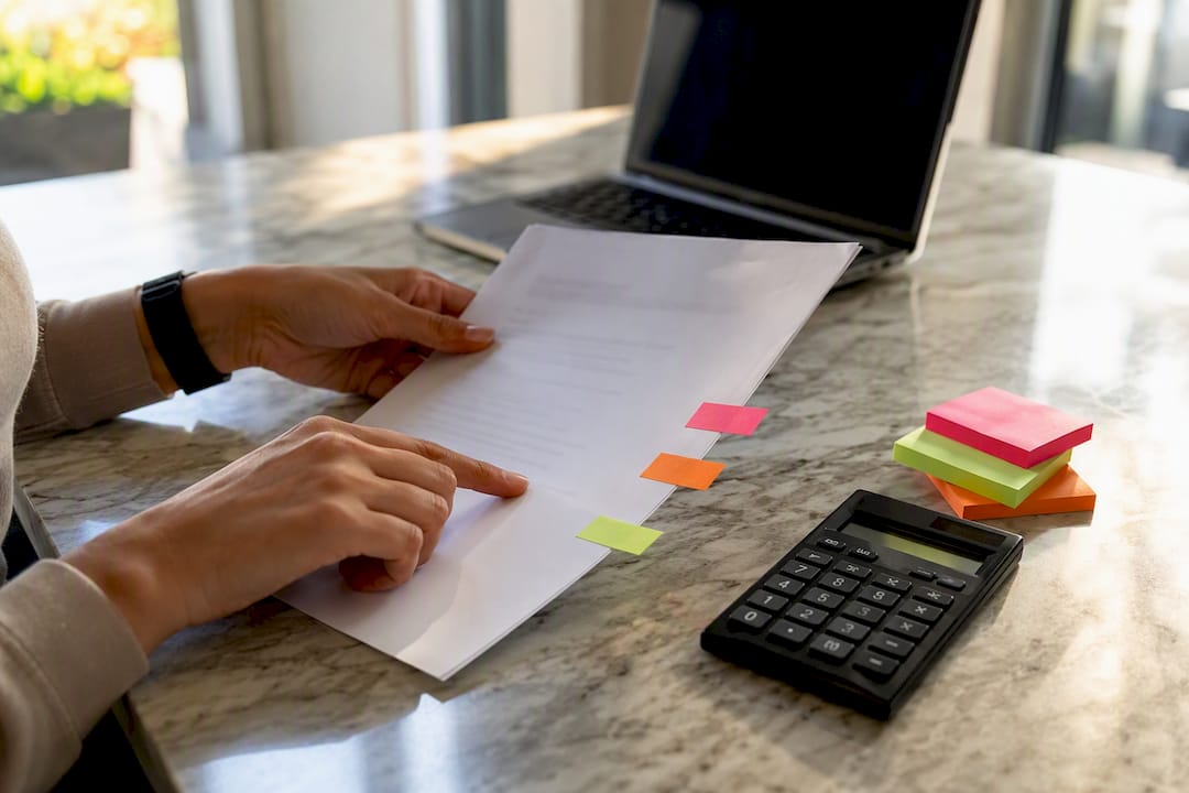 Hands pointing to income lines on letter