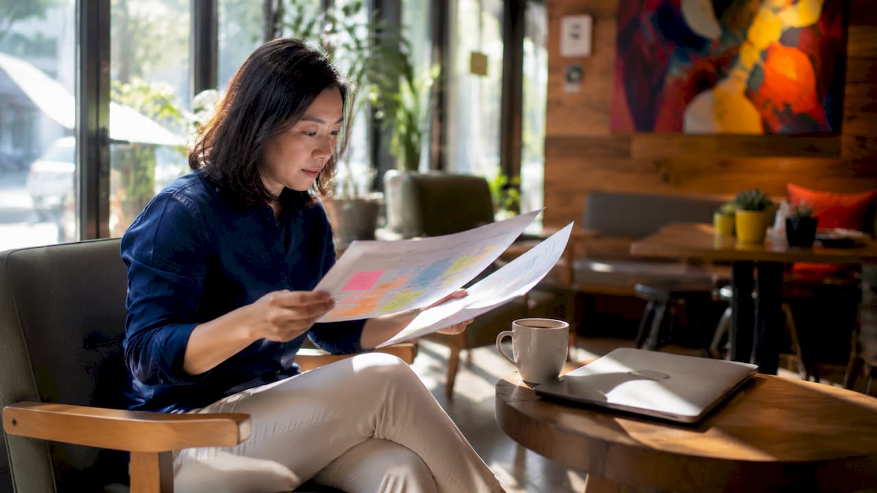 Qualities of an aligned creative agency: 2026 guide 2 • MB Brand Communications Hands reviewing agency project plan documents