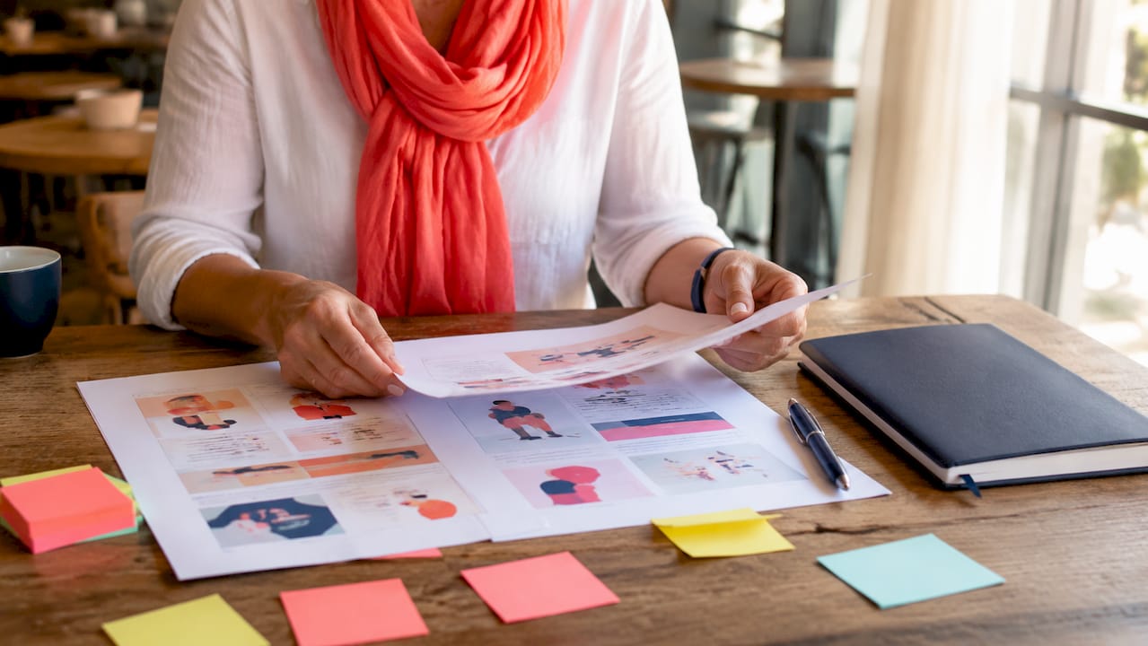 Modernise legacy brand communications: a leader's guide 2 • MB Brand Communications Close-up of hands reviewing messaging audit documents
