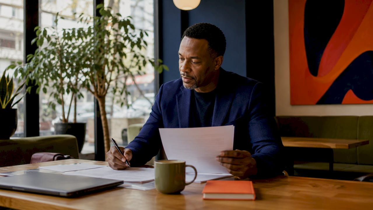 Man reviewing brand meaning notes at desk