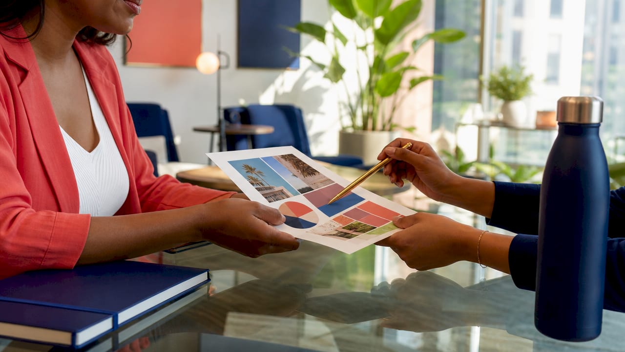 Role of internal communications in marketing 2 • MB Brand Communications Hands exchanging feedback notes at office desk