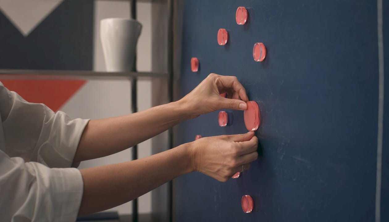 Hands moving budget allocation markers