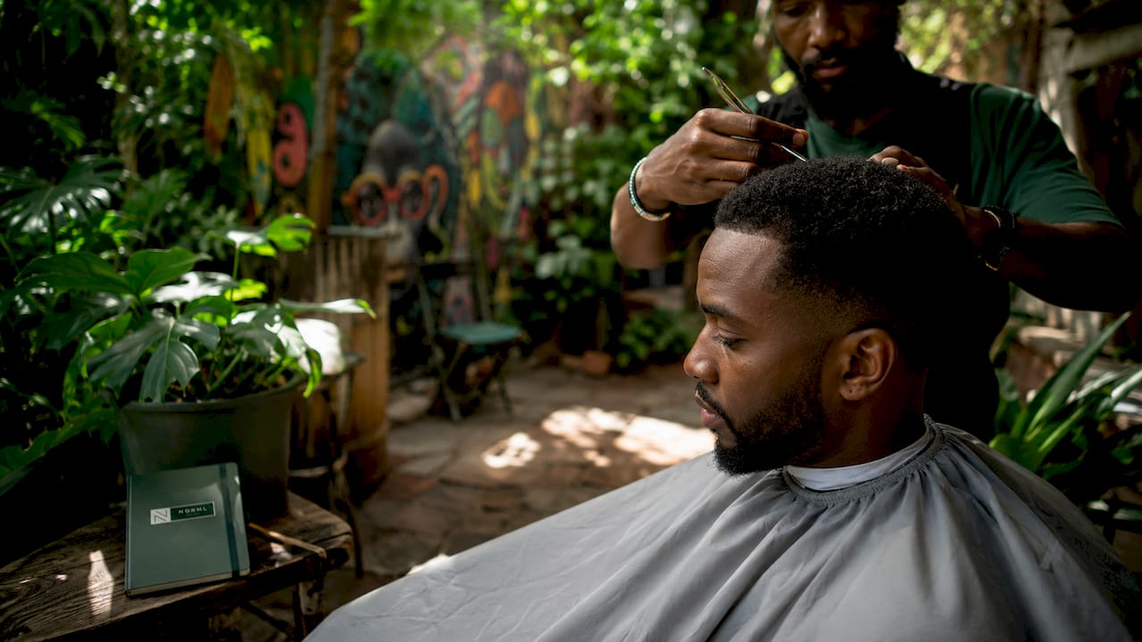 Man getting hair trimmed at barber shop