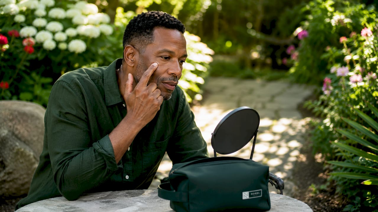 Man applying concealer for natural finish