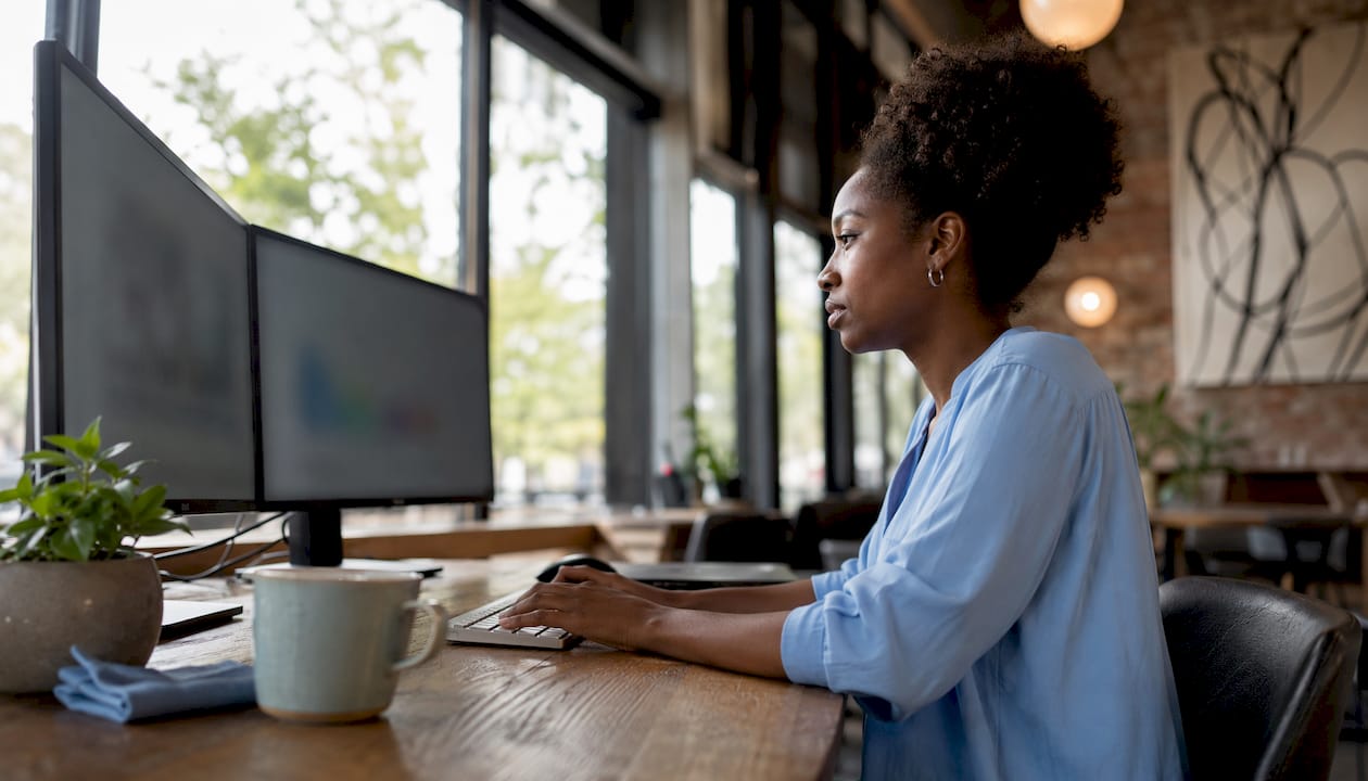 Woman managing Google Ads campaigns in home office