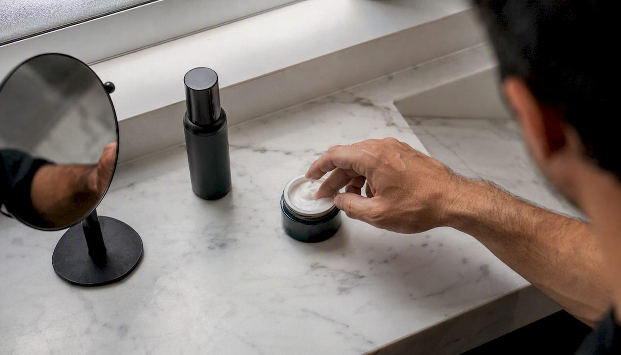 Hand scooping moisturizer for morning skincare routine