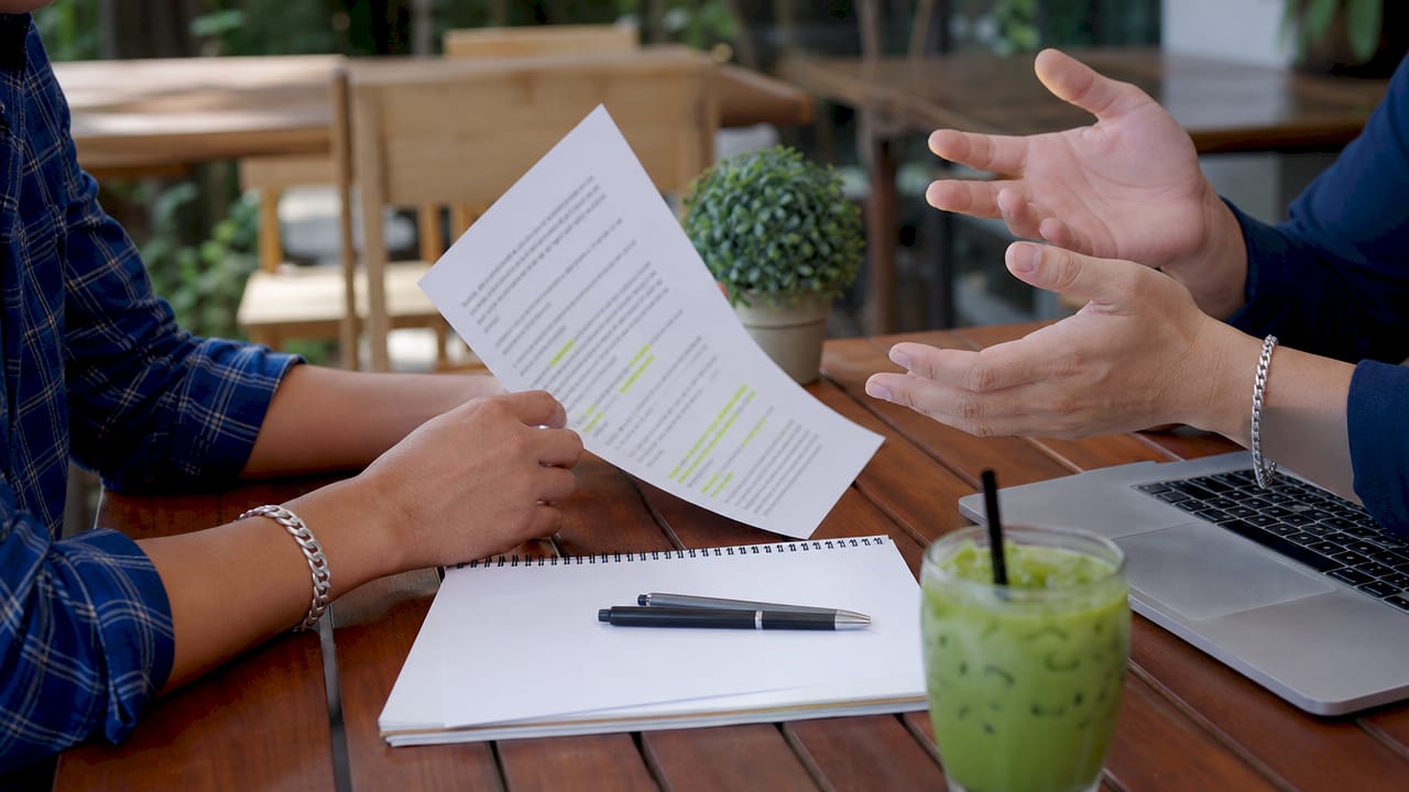 Hands discussing negotiation contract terms