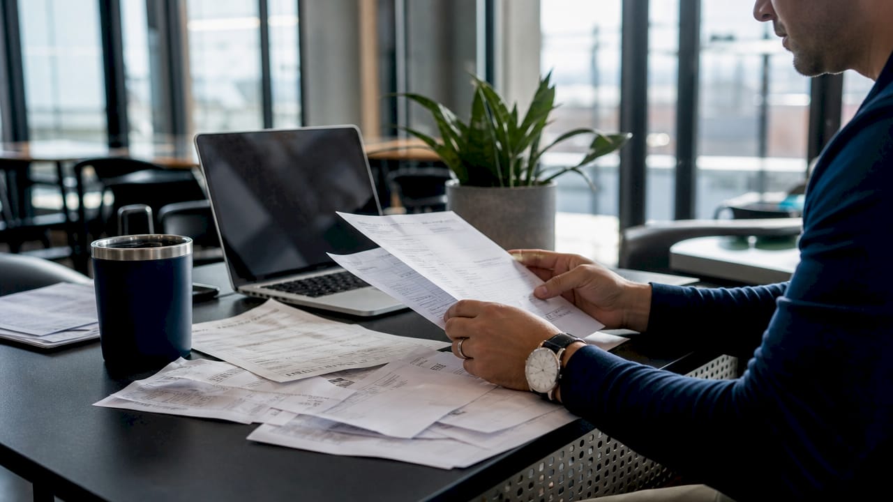 Hands organizing fixed trucking expense receipts