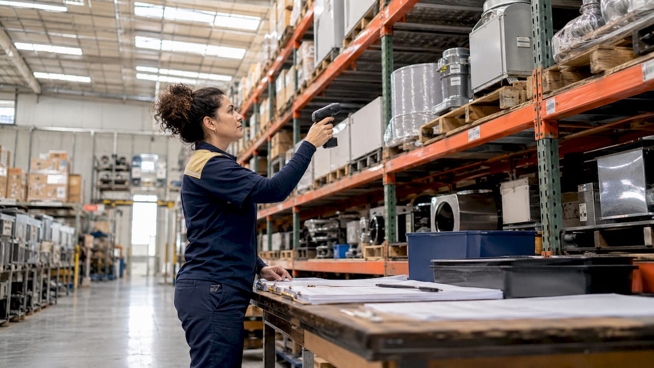 Hands scanning HVAC inventory parts in warehouse