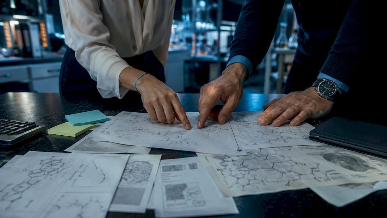Hands examining peptide molecular patent documents