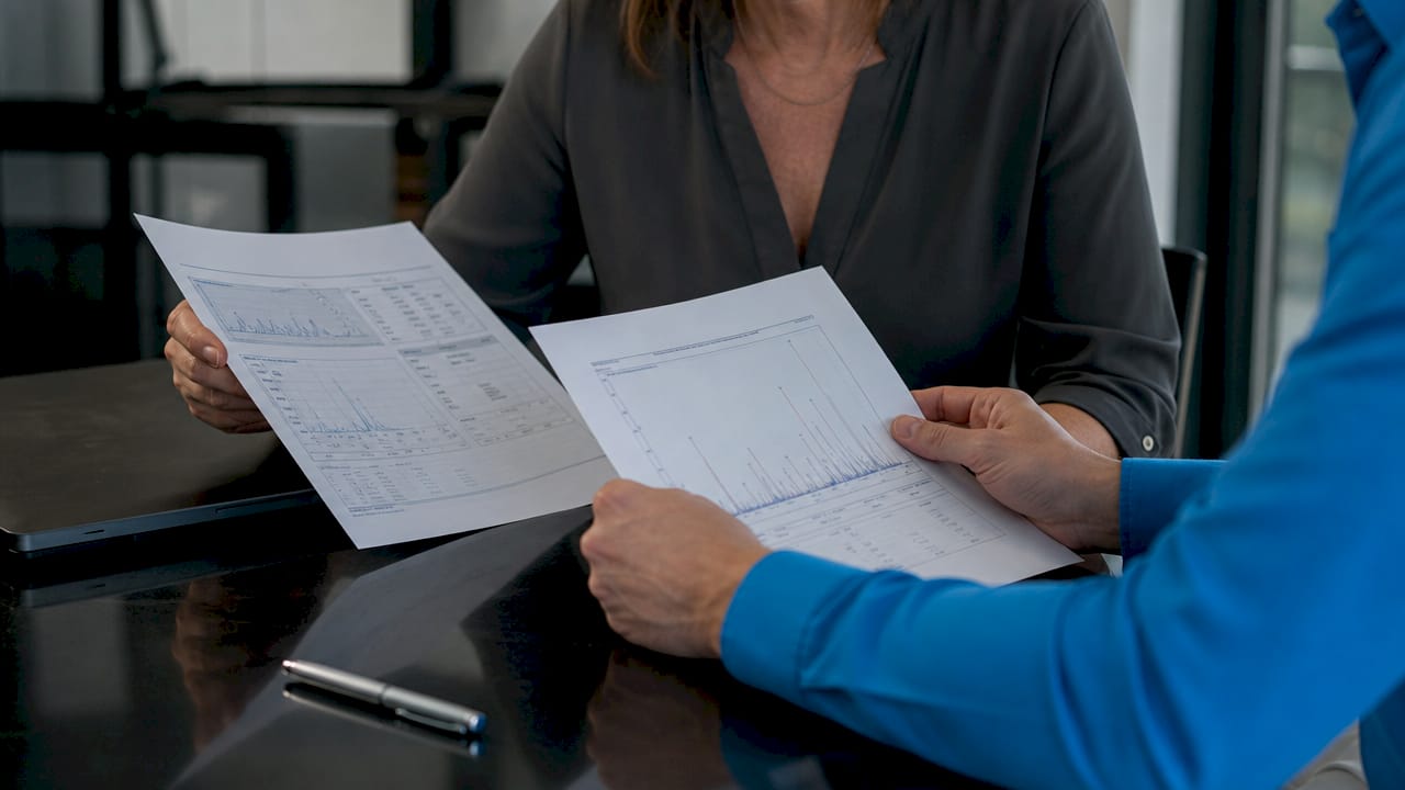Hands comparing peptide Certificates of Analysis