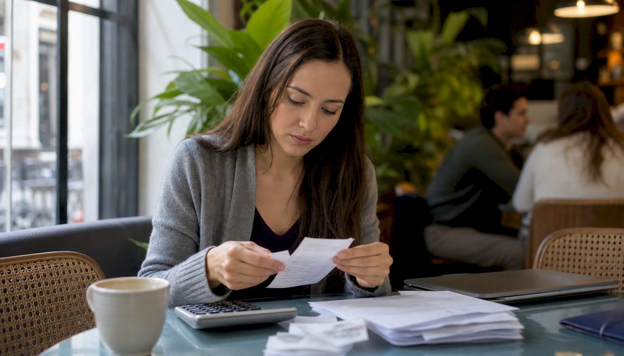 Small business owner scanning receipts at desk