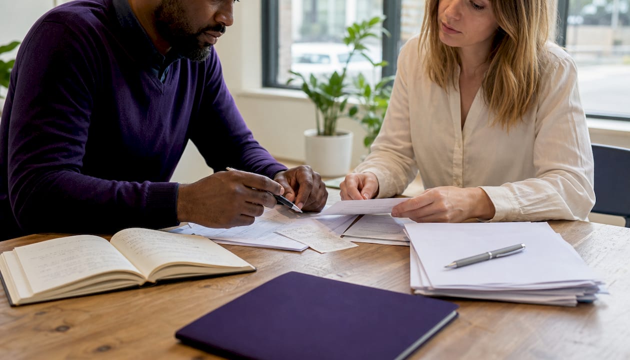 Close-up of hands sorting payroll documents together