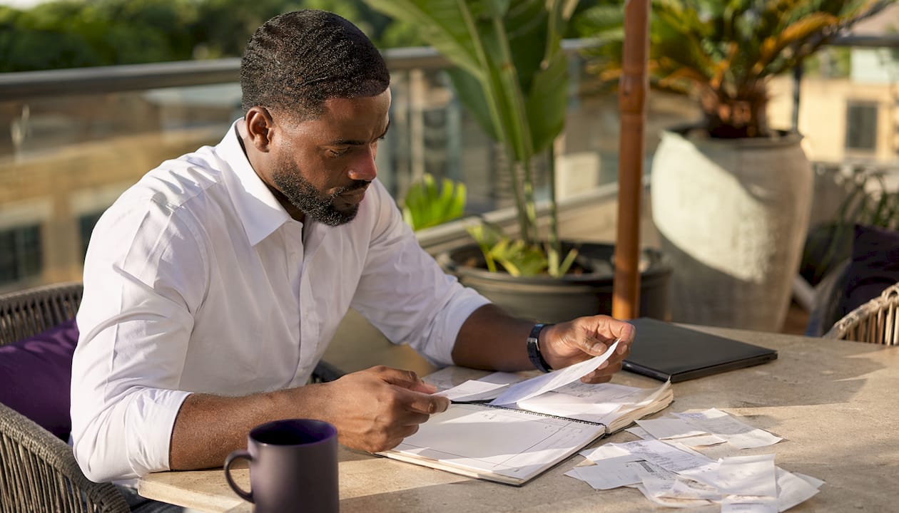 Hands sorting invoices and financial papers
