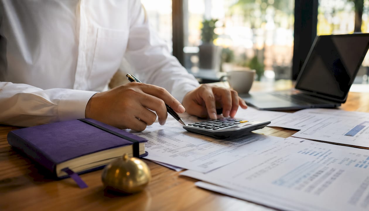 Accountant calculating payroll taxes paperwork