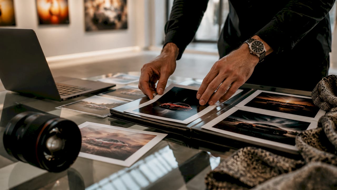 Close-up of hands sorting photographic prints