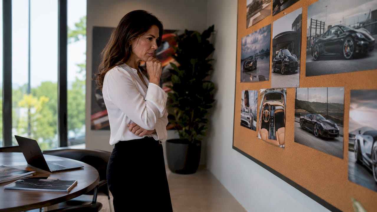 Marketing manager reviewing printed vehicle photos in office