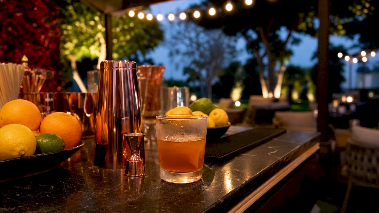 Mixology tools and branded cocktail setup on bar counter