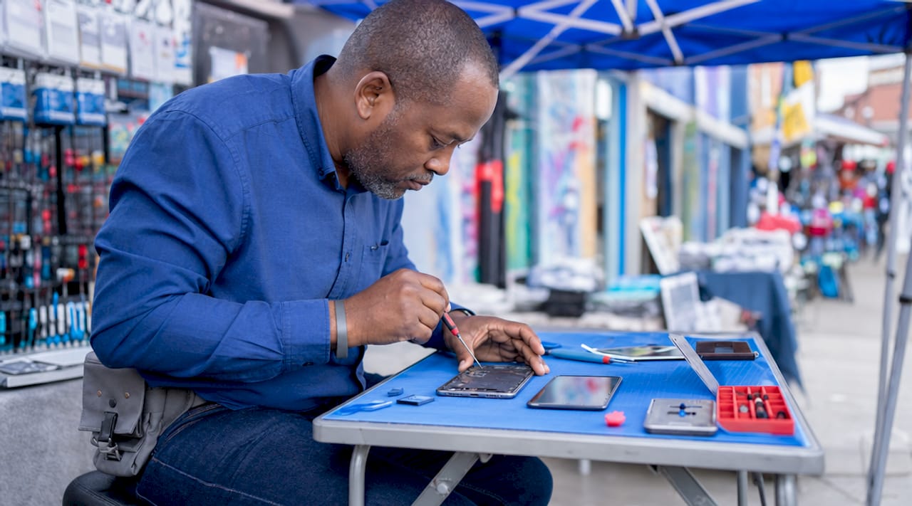 Technician repairing smartphone screen in Hackney shop