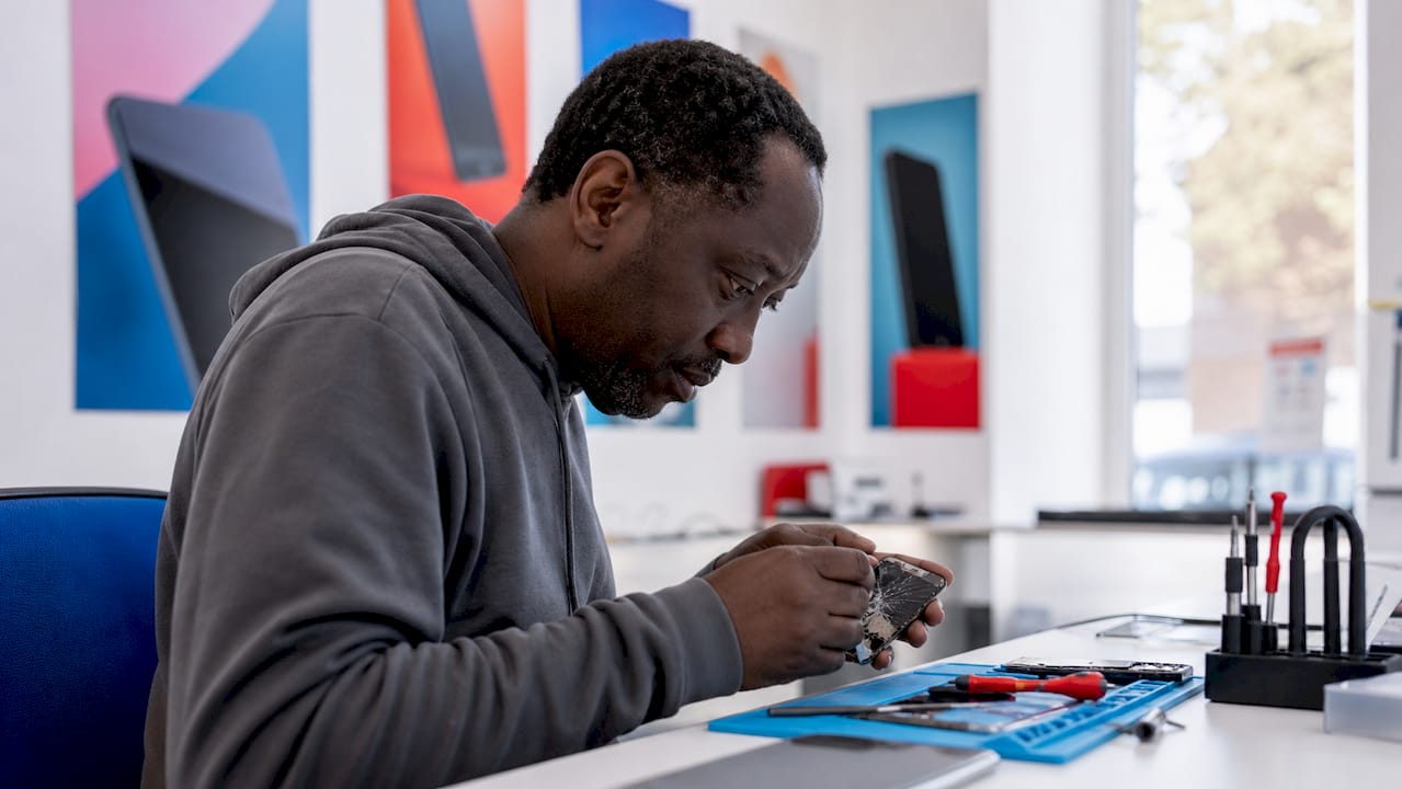Technician repairing phone screen at Wood Green shop